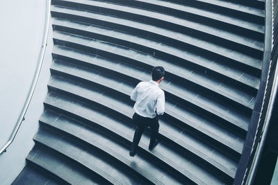 High angle view of businessman climbing on steps