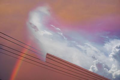 Double exposure view of rainbow against sky during sunset