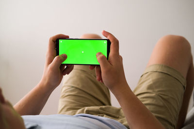 Midsection of woman using mobile phone