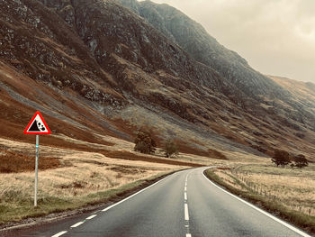 Road amidst mountains against sky