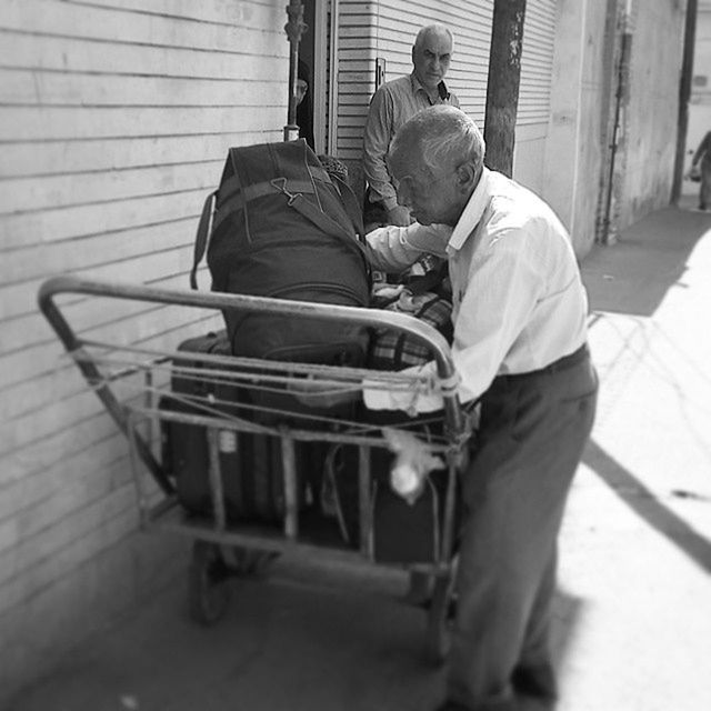 full length, sitting, architecture, rear view, built structure, building exterior, chair, childhood, side view, casual clothing, men, day, indoors, lifestyles, sunlight, animal themes, house, boys