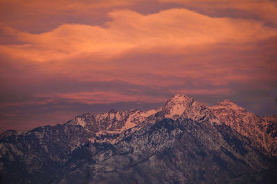 Scenic view of snowcapped mountains against sky during sunset