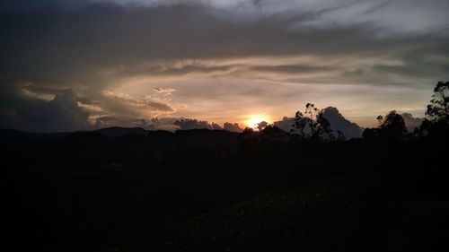 Silhouette landscape against sky during sunset