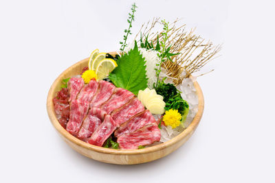 Close-up of vegetables in plate against white background