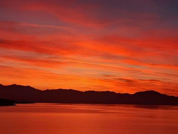 Scenic view of lake against romantic sky at sunset