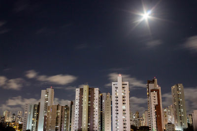 Low angle view of illuminated buildings against sky