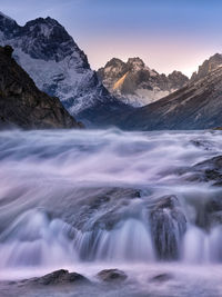 Scenic view of waterfall against sky