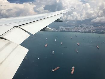 Cropped image of airplane flying over clouds