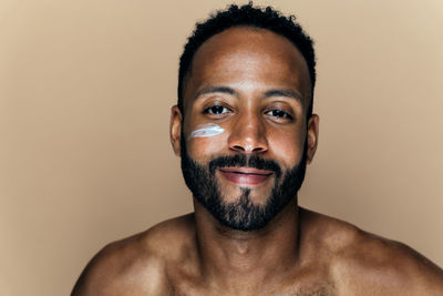 Portrait of young man against white background