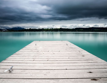 Pier over lake against sky