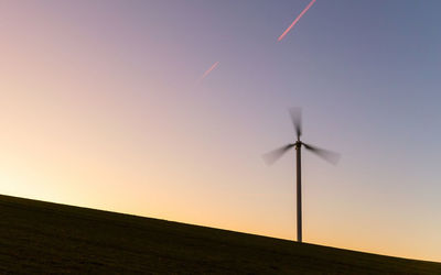 Low angle view of windmill against sky during sunset