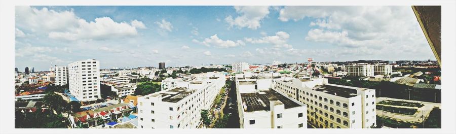 Buildings against cloudy sky