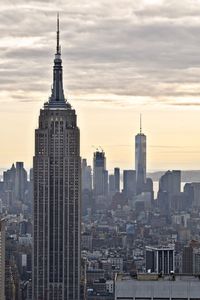 View of cityscape against cloudy sky