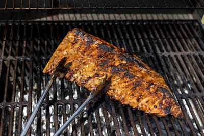 A closeup shot of meat being grilled on a grill outdoors