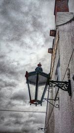 Low angle view of built structure against cloudy sky