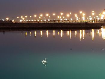 Scenic view of lake against sky at night