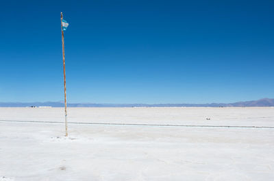 Scenic view of beach against blue sky