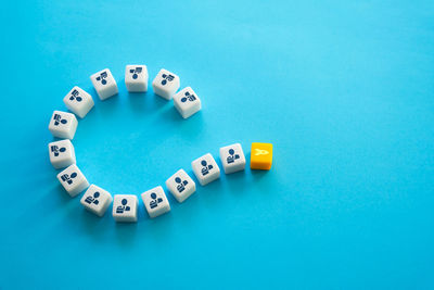 High angle view of dices on blue background