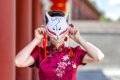 Midsection of woman wearing mask