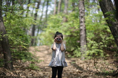 Portrait of girl standing in forest