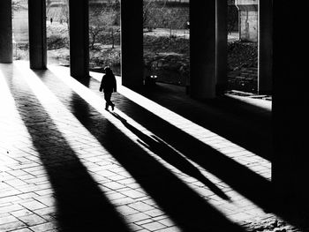 Rear view of woman walking on street