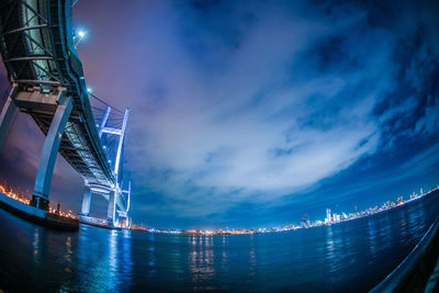 Low angle view of illuminated bridge against sky at night