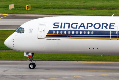 Side view of airplane on airport runway