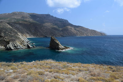 Scenic view of sea and mountains against sky