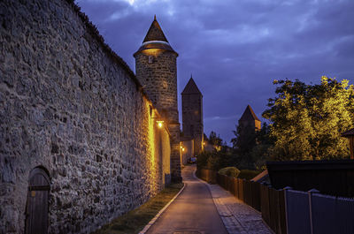 Illuminated historic building against sky at dusk