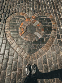 Low section of man standing on footpath