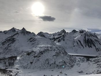 Scenic view of snow covered mountains against sky