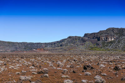 Scenic view of rocky mountains against clear blue sky