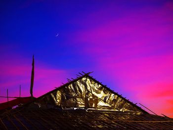 Tilt image of roof against sky at sunset