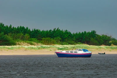 Nautical vessel on beach against clear sky