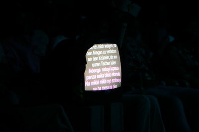 Silhouette man sitting in illuminated room