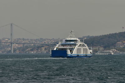 Ship sailing in sea against sky