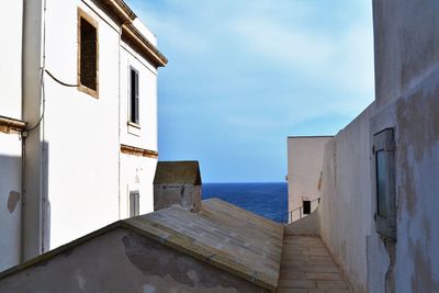 View of sea with houses in background