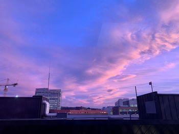 Low angle view of buildings against sky during sunset