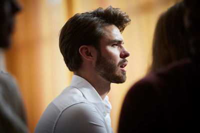 Side view of confused businessman looking away in office workshop