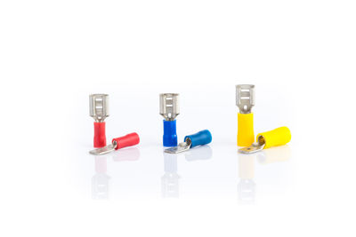 Close-up of colored pencils over white background