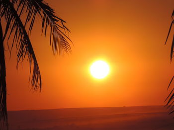 Scenic view of sea against orange sky