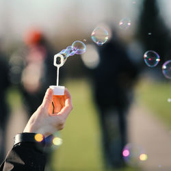 Close-up of hand holding bubble wand