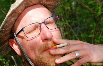 Close-up portrait of man smoking cigarette