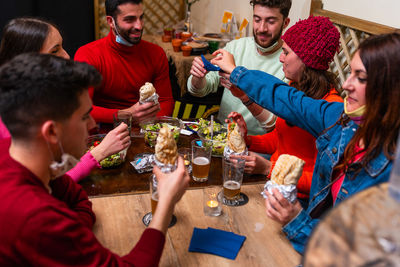 Caucasian young people eating at pub. group of happy friends having breakfast in the restaurant