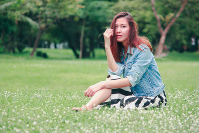 Young woman sitting on field