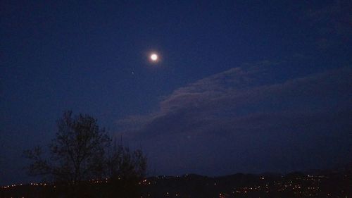 Low angle view of moon in sky at night