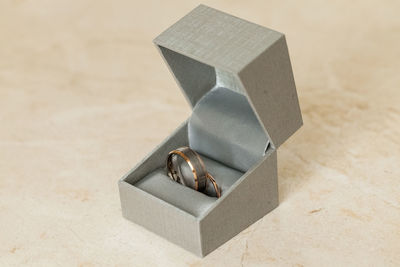 Close-up of wedding rings in box on table