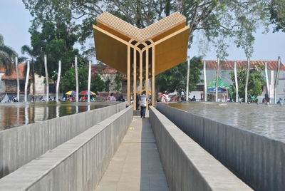 Rear view of man in front of modern building