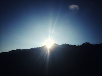 Sun shining over mountains