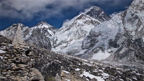 Low angle view of snowcapped mountains against sky